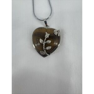 Heart Shaped Brown Pendant With A Silver Necklace